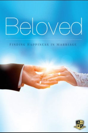 An image of a couple at their wedding holding hands